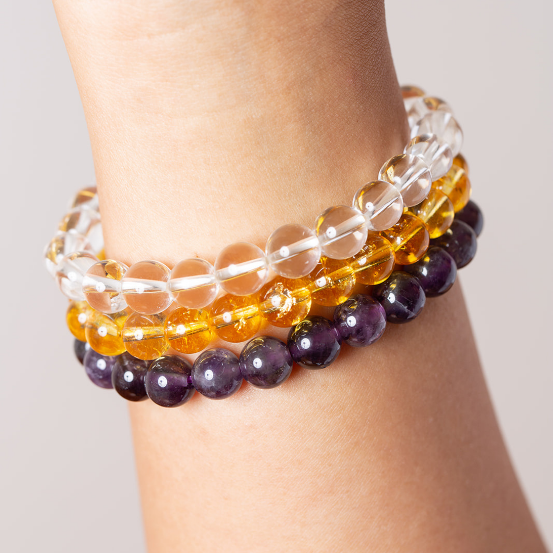 Women's wrist with Ambarya clear quartz, citrine and amethyst mala beads