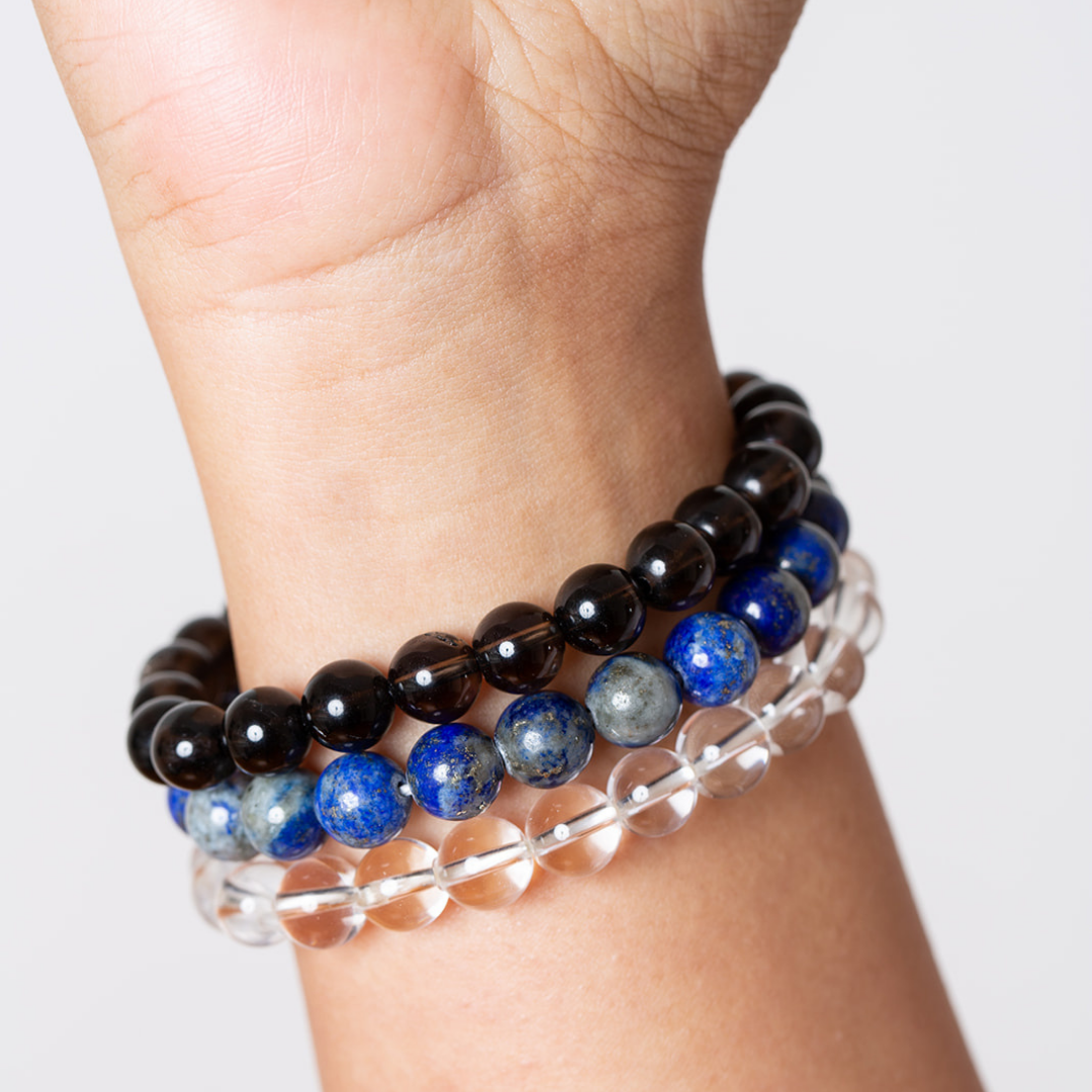 women's wrist with Ambarya smoky quartz, lapis lazy=uli and clear quartz mala beadsz