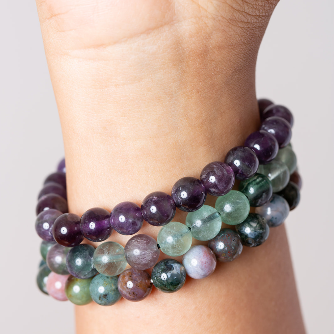women's wrist with Ambarya amethyst, rainbow fluorite and bloodstone mala beads