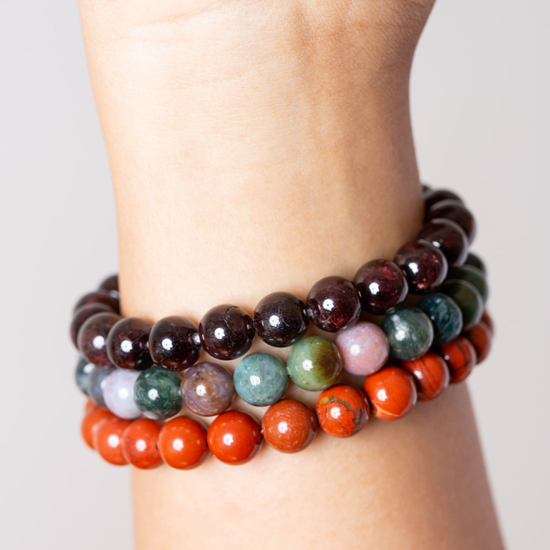 Women's wrist with garnet, bloodstone and red jasper mala beads