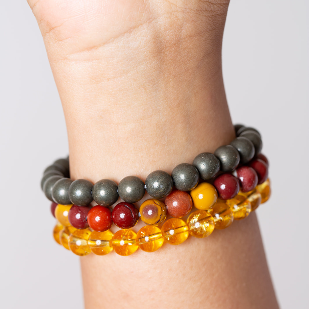 women's wrist with Ambarya pyrite, mookaite and citrine mala beads